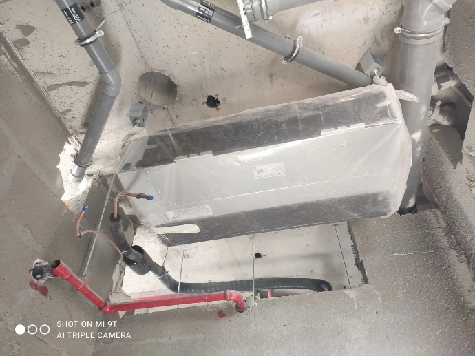 Ducted indoor AC unit connected to project ceiling pipework